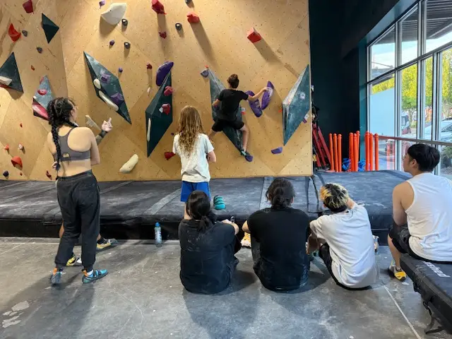 climbers watching others on the wall